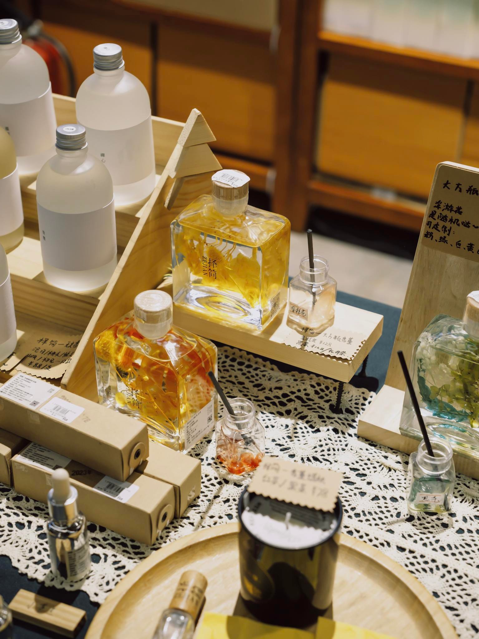 A stylish composition featuring assorted perfume bottles and accessories on a lace-covered table.