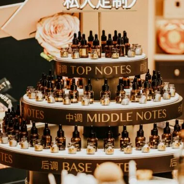 Luxurious perfume display with top, middle, and base notes bottles indoors.